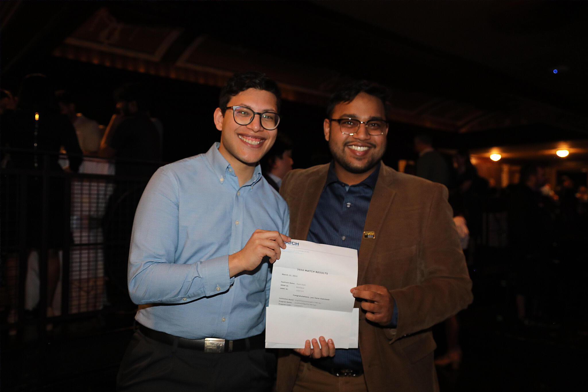 A photo of two men holding a piece of paper