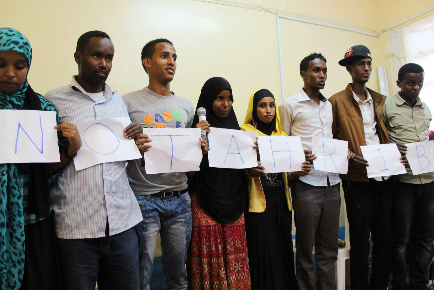At the mental health clinic in Nairobi, youth leaders and staffers perform a play that dealt with human trafficking (or “tahrib” in Somali). They are holding a sign that says “No Tahrib.
<br>Photo by Hyojin Im.