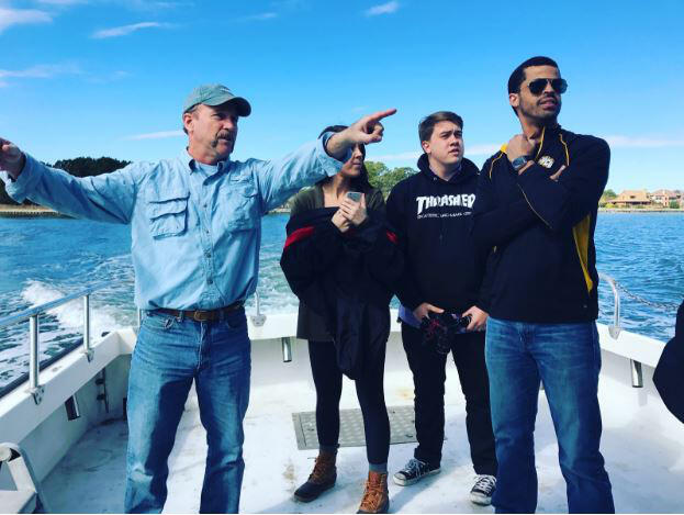 Captain Billy D, left, shows off the Chesapeake Bay to VCU InSight student journalists Alexandra Johnson and John Hood, and co-news director Sean Collins-Smith. Tangier Island could be fully enveloped by the Chesapeake in as little as 25 years.