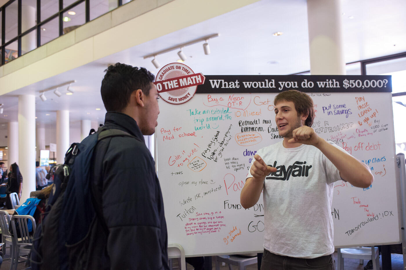 Sophomore Dominic Gavan of Leesburg (right) explains to sophomore Issmeal Anany the financial benefit of committing to taking 15 credits a semester.