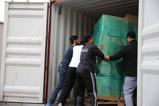 United2Heal volunteers load items into the container being shipped to Syria.