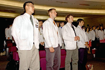 From left: third year VCU School of Medicine Students Young Hong, Mike White, Chris Hartness and Brian Showalter prepare to recite the compact during the Arnold P. Gold Foundation Student Clinician’s Ceremony. The compact serves both as a pledge and reminder to teachers and students that their conduct in fulfilling their mutual obligations is the medium through which the profession instills its ethical values.