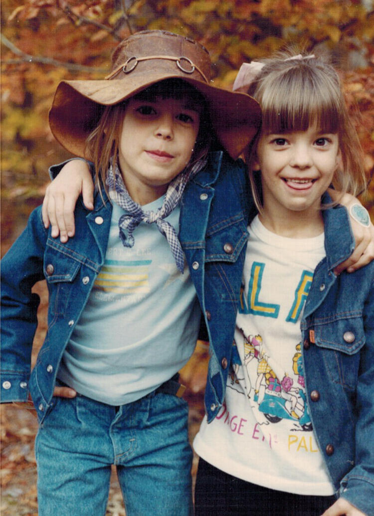 Cathy, left, and Christine Davison, age 7, standing in the front yard of their childhood home in Spotsylvania County.