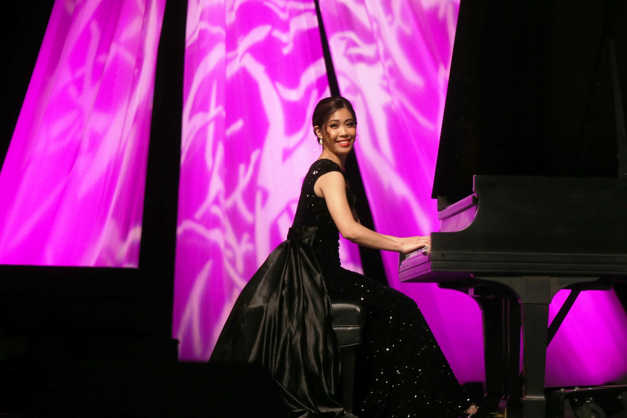 A photo of a woman playing the piano
