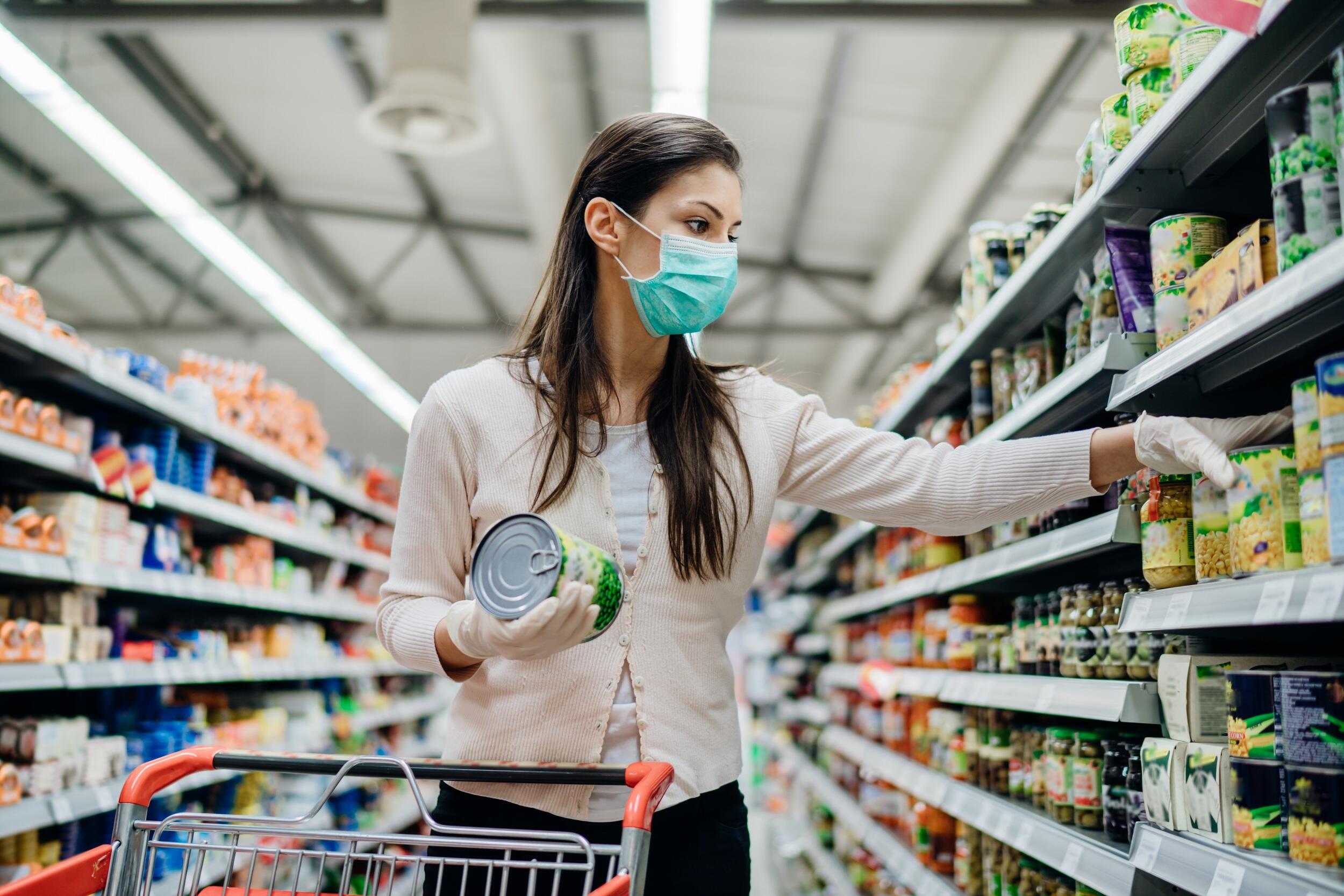 A person wearing a mask while shopping at a grocery store.