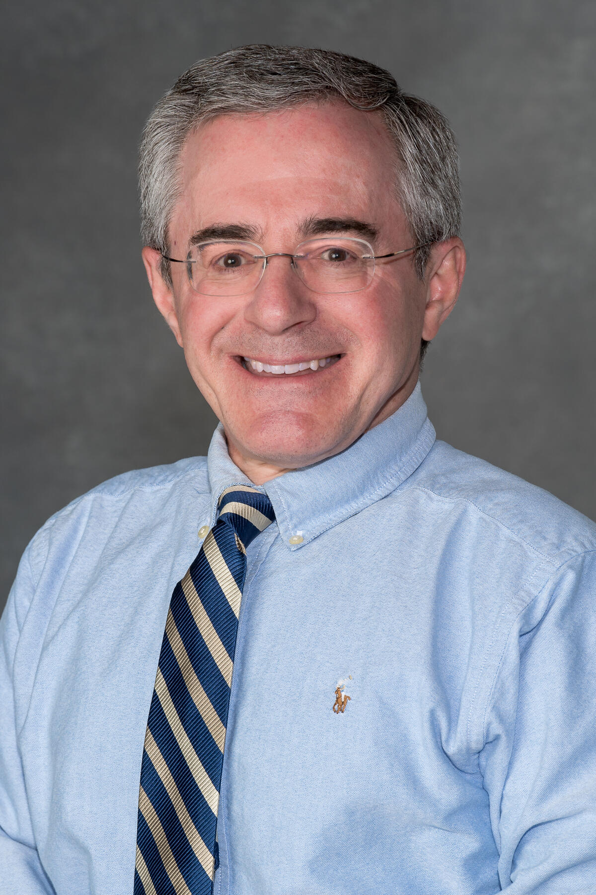 A portait of a man from the chest up. 