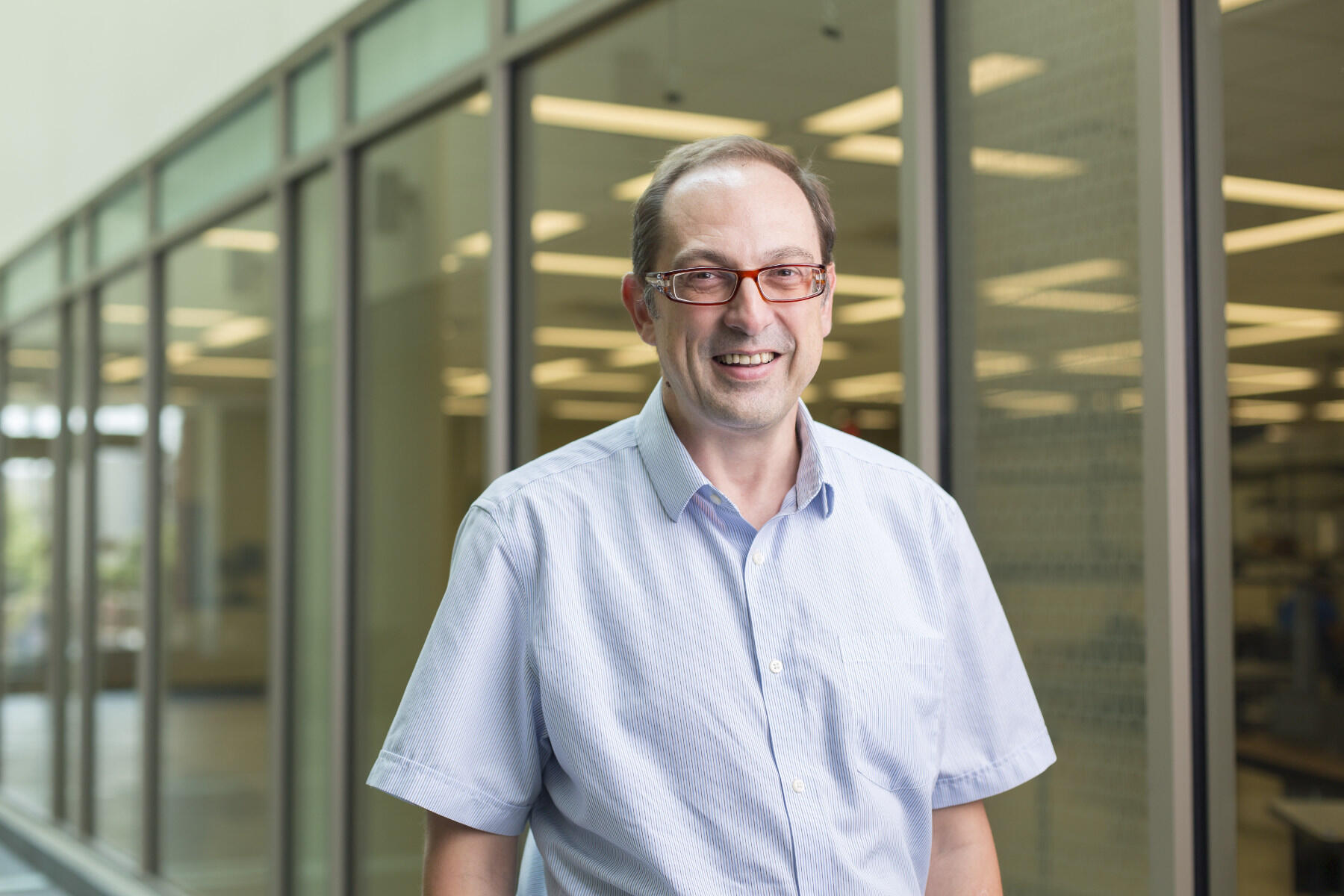 Man wearing glasses and blue shirt