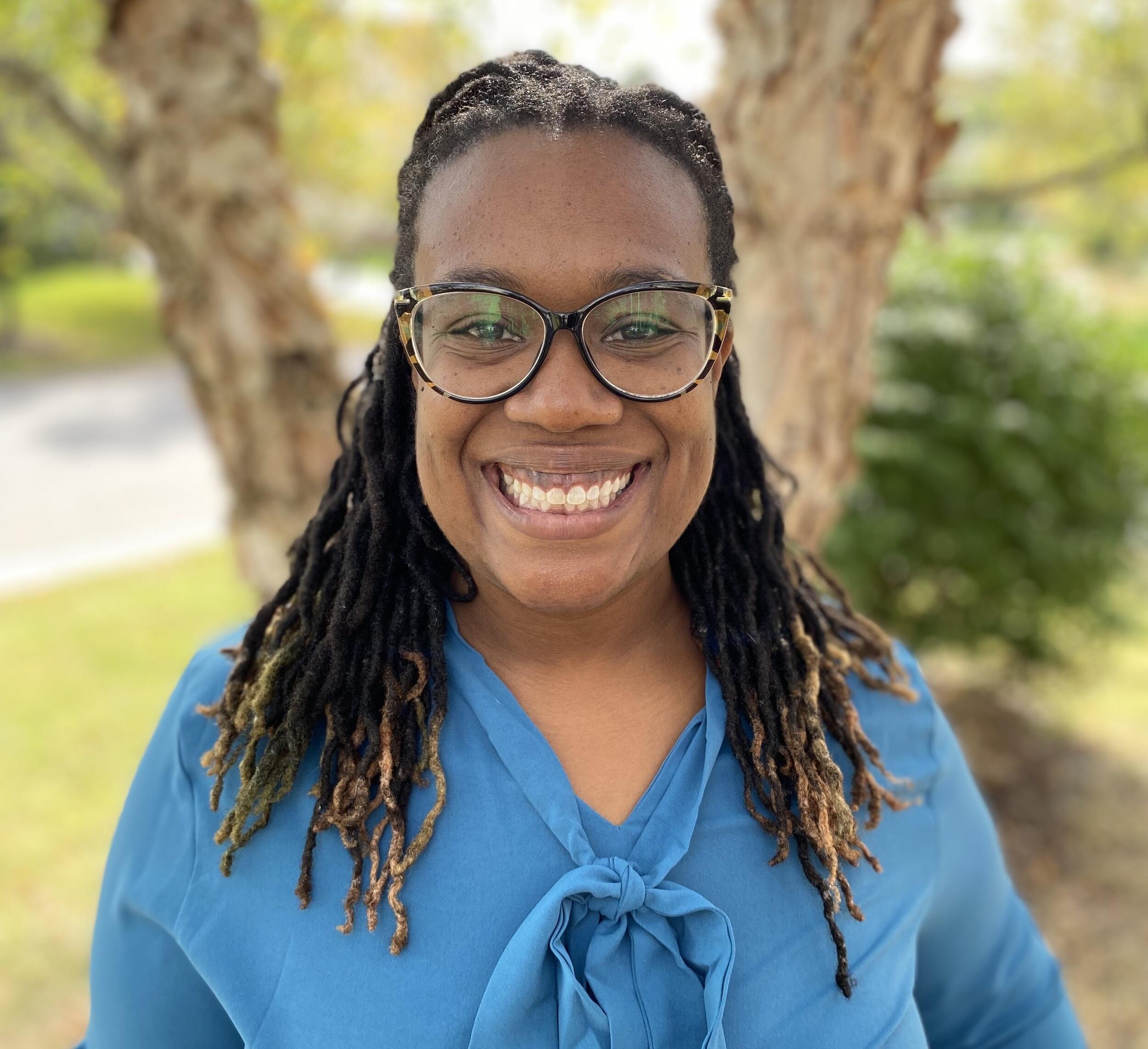 A photo of a woman from the chest up. 