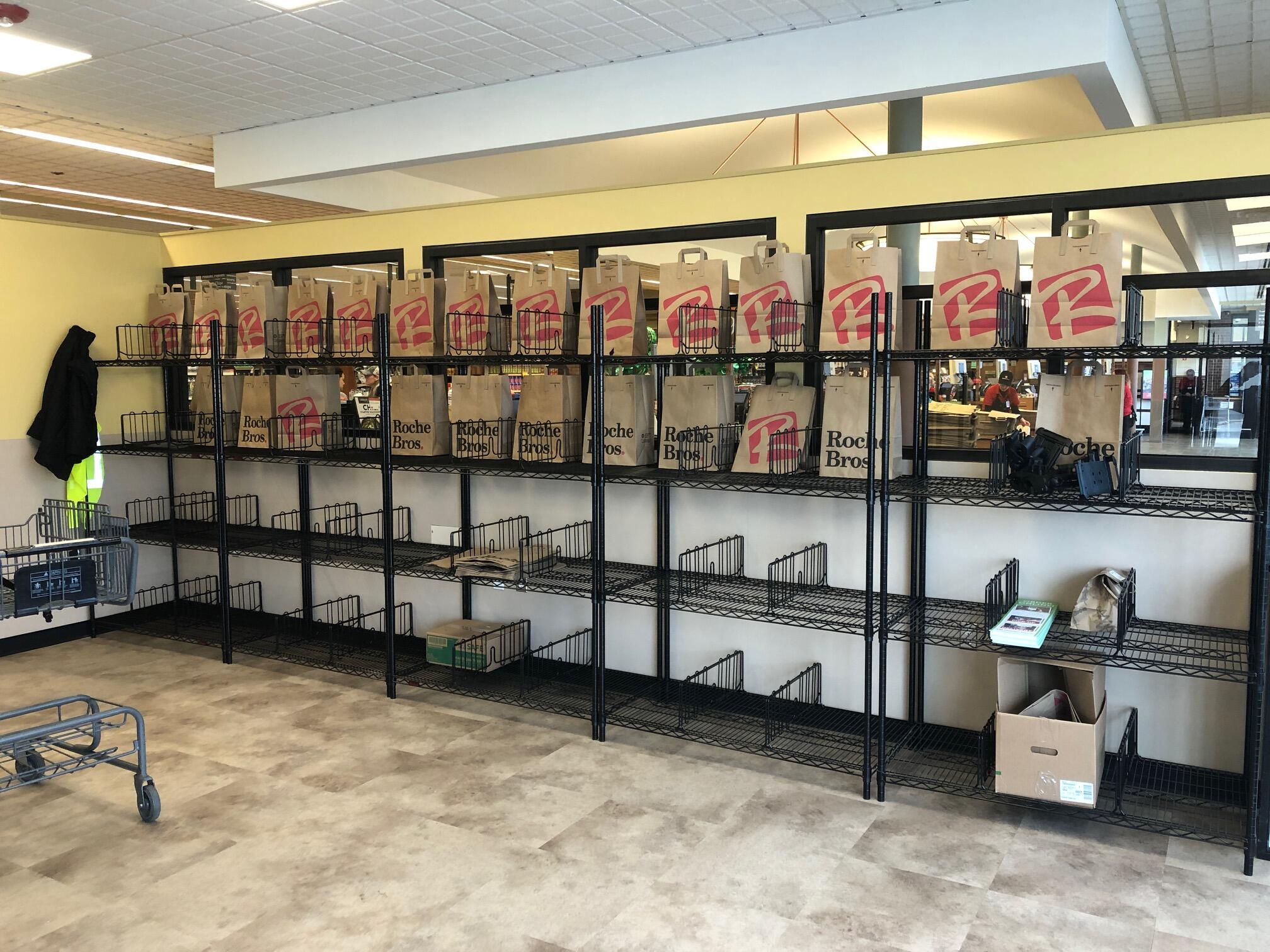 Racks of paper grocery bags in a supermarket.