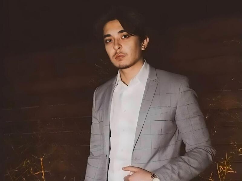 A portait of a man from the waist up 