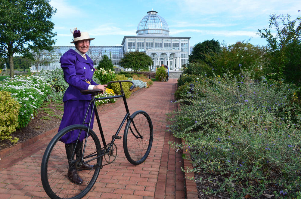 Sherry Giese wears a late 1800s costume and shows off Lewis Ginter Botanical Garden's Brewster 1890s lady's bicycle that was fixed up by Jesse McCauley. Photo courtesy Lewis Ginter Botanical Garden