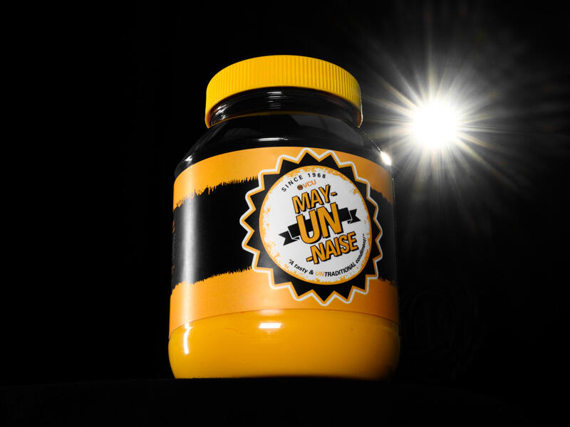 A jar of black and gold mayonnaise with a \"VCU May-UN-naise\" label.