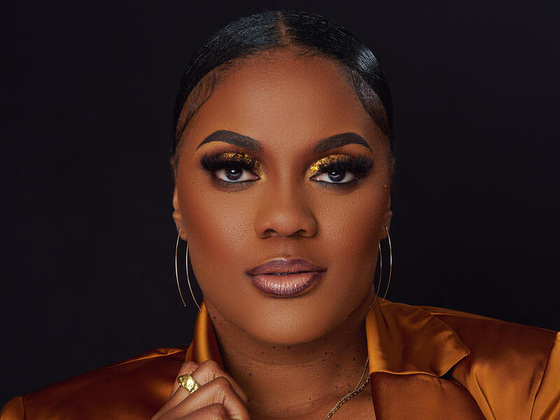 A photo of a woman from the shoulders up. 