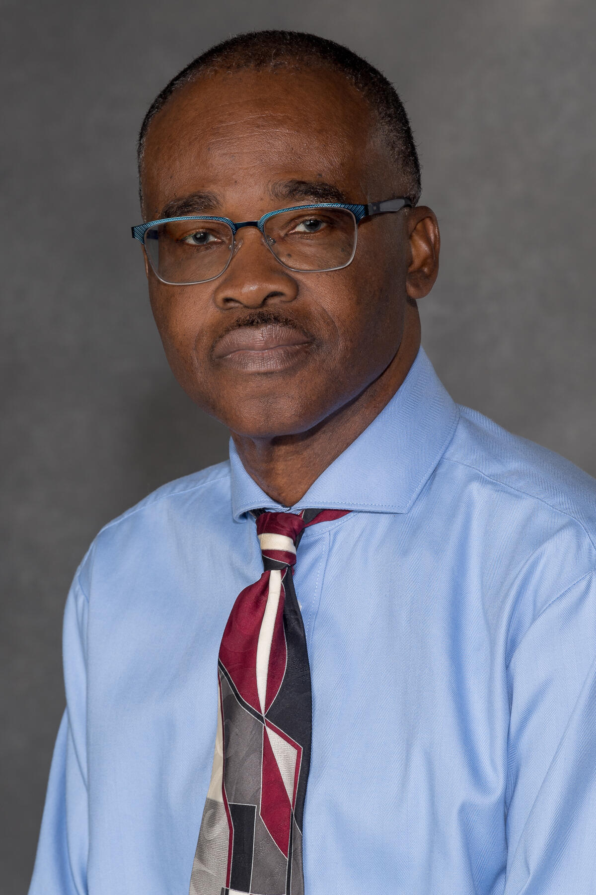 A portait of a man from the chest up. 