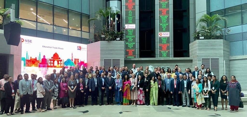 A large group of people standing in front of a stock exchange 