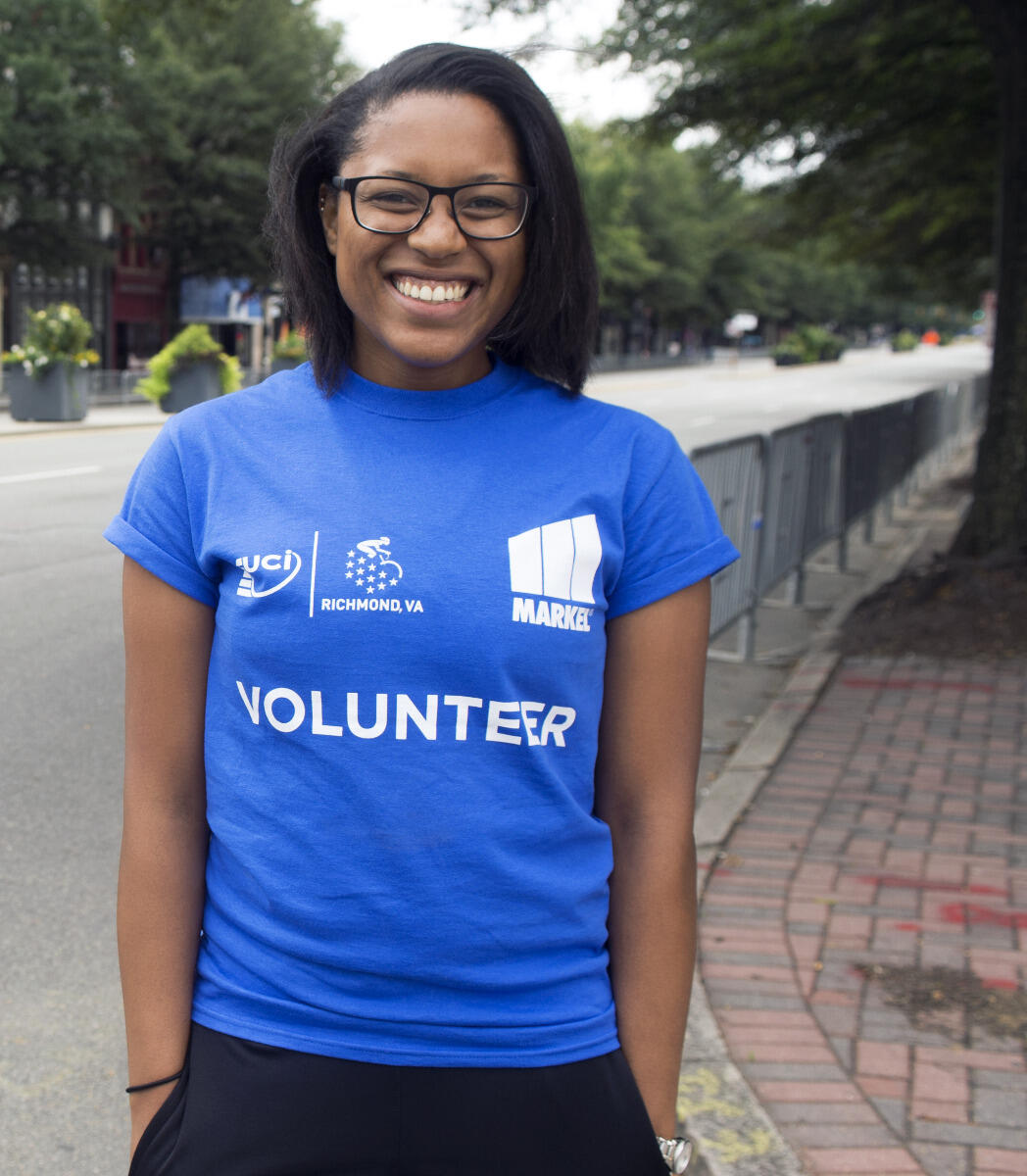 Jazmine Parker, a senior anthropology major, volunteered as a course marshal, helping fans cross Broad Street on Monday. 
