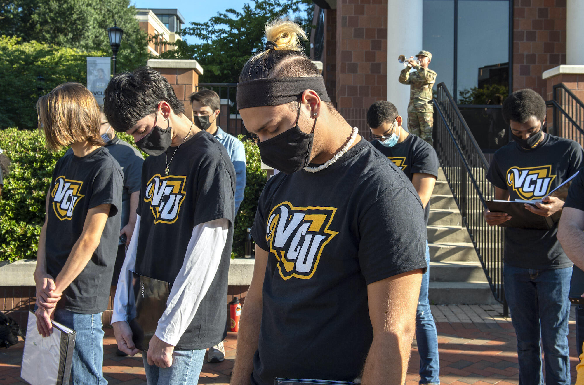 Students participate in a moment of silence at a 9/11 anniversary event.
