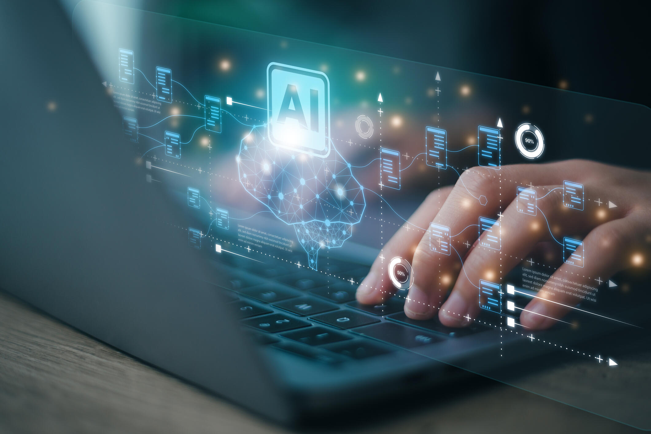 A photo of a hand typing on a laptop. In front of the laptop screen is a projection that shows an illustration of a brain and text that reads \"AI\"