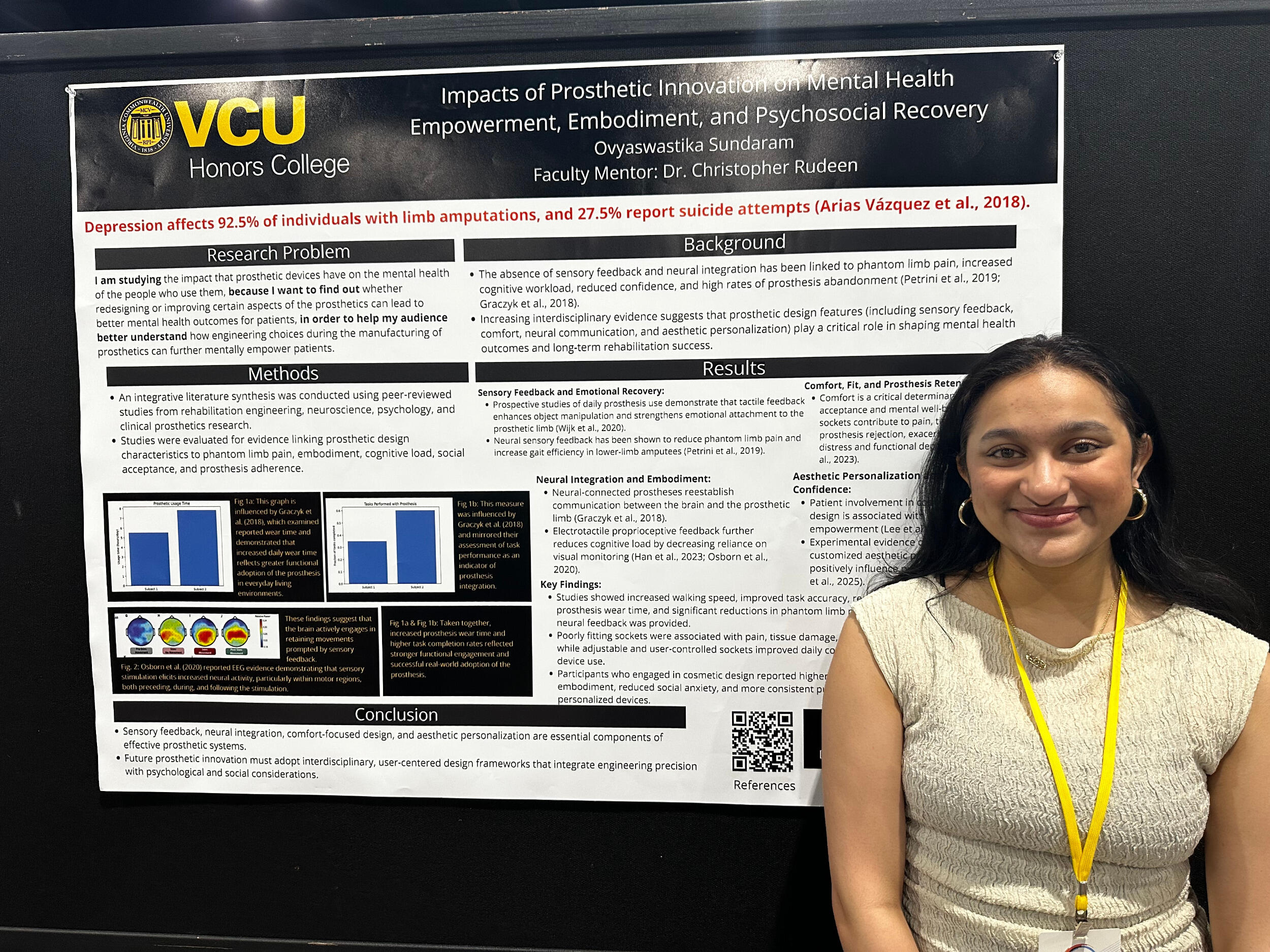 A woman stands in front of a research poster board.