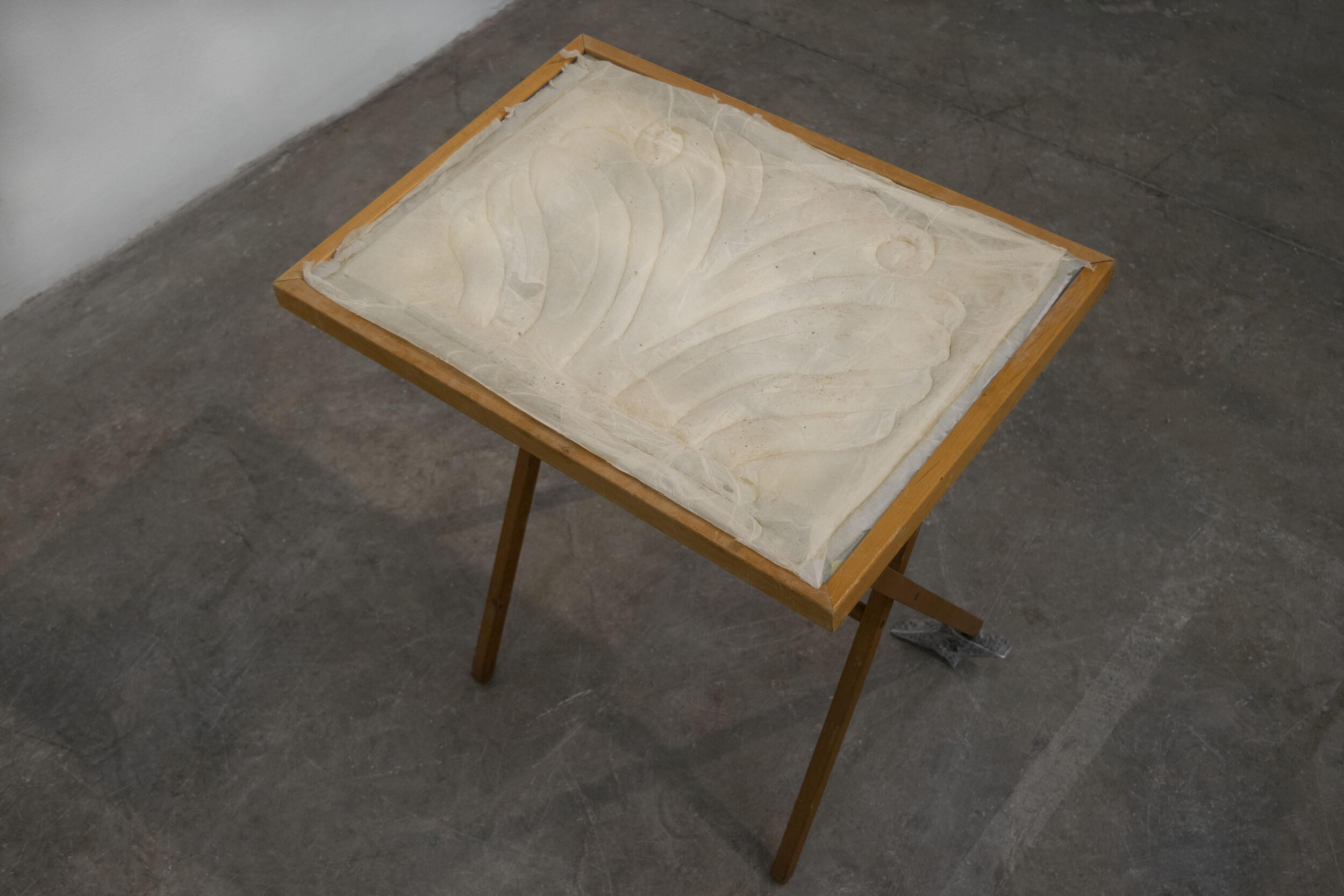 An image of a table with something cream covering the top