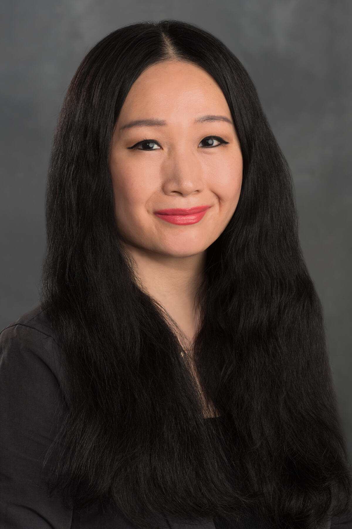 A portait of a woman from the chest up. 