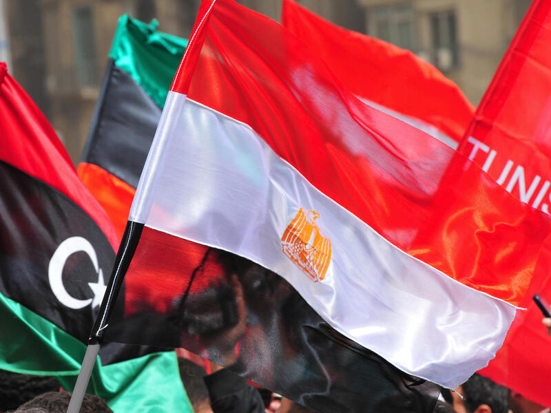 A photo of flags blowing in the wind. 