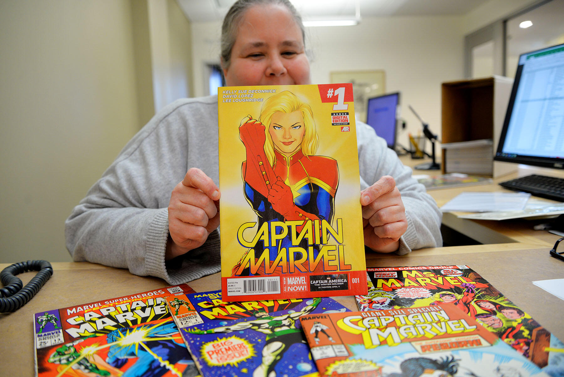 Woman holding an open comic book.