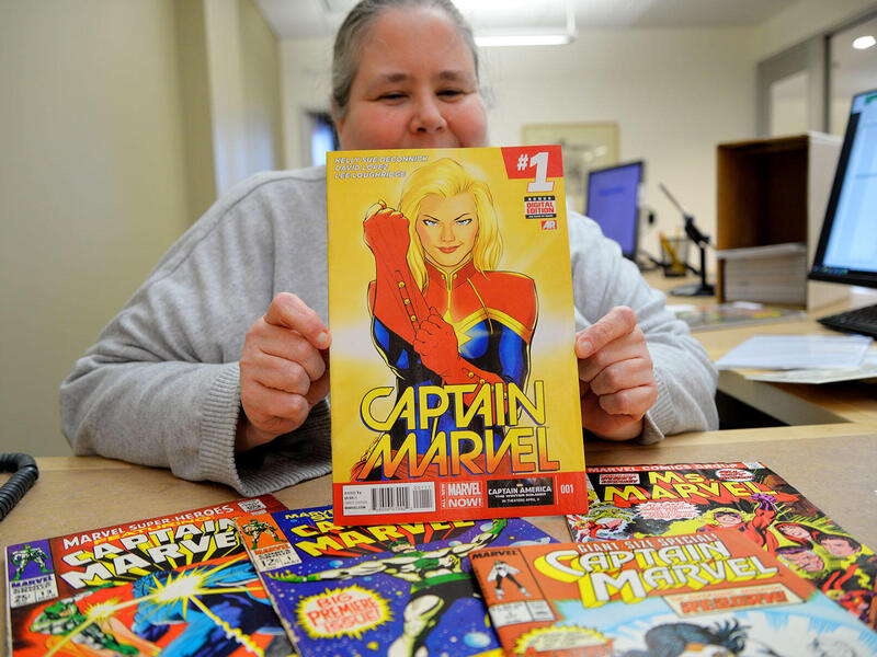 Woman holding an open comic book.