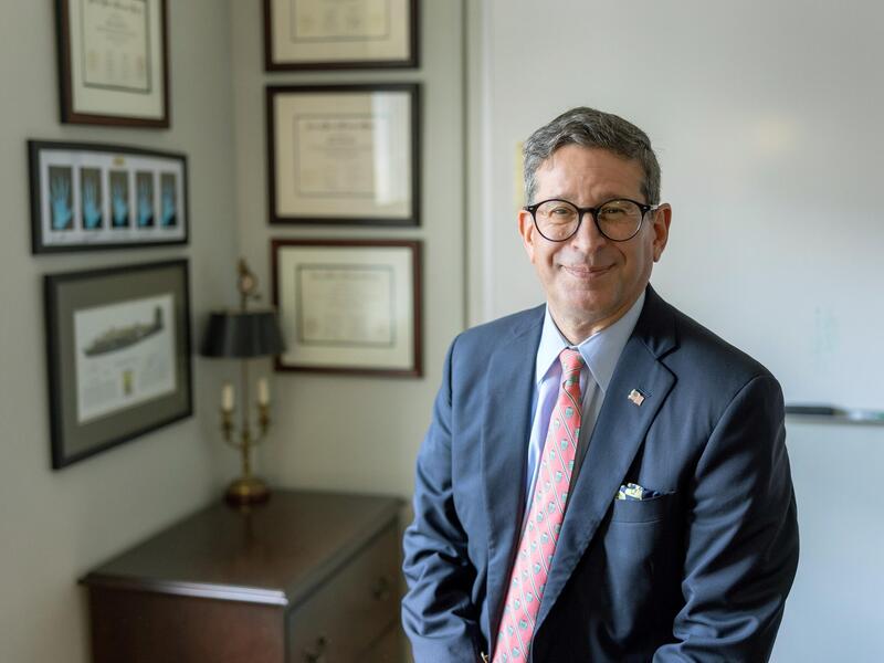 A photo of a man sitting in an office. 