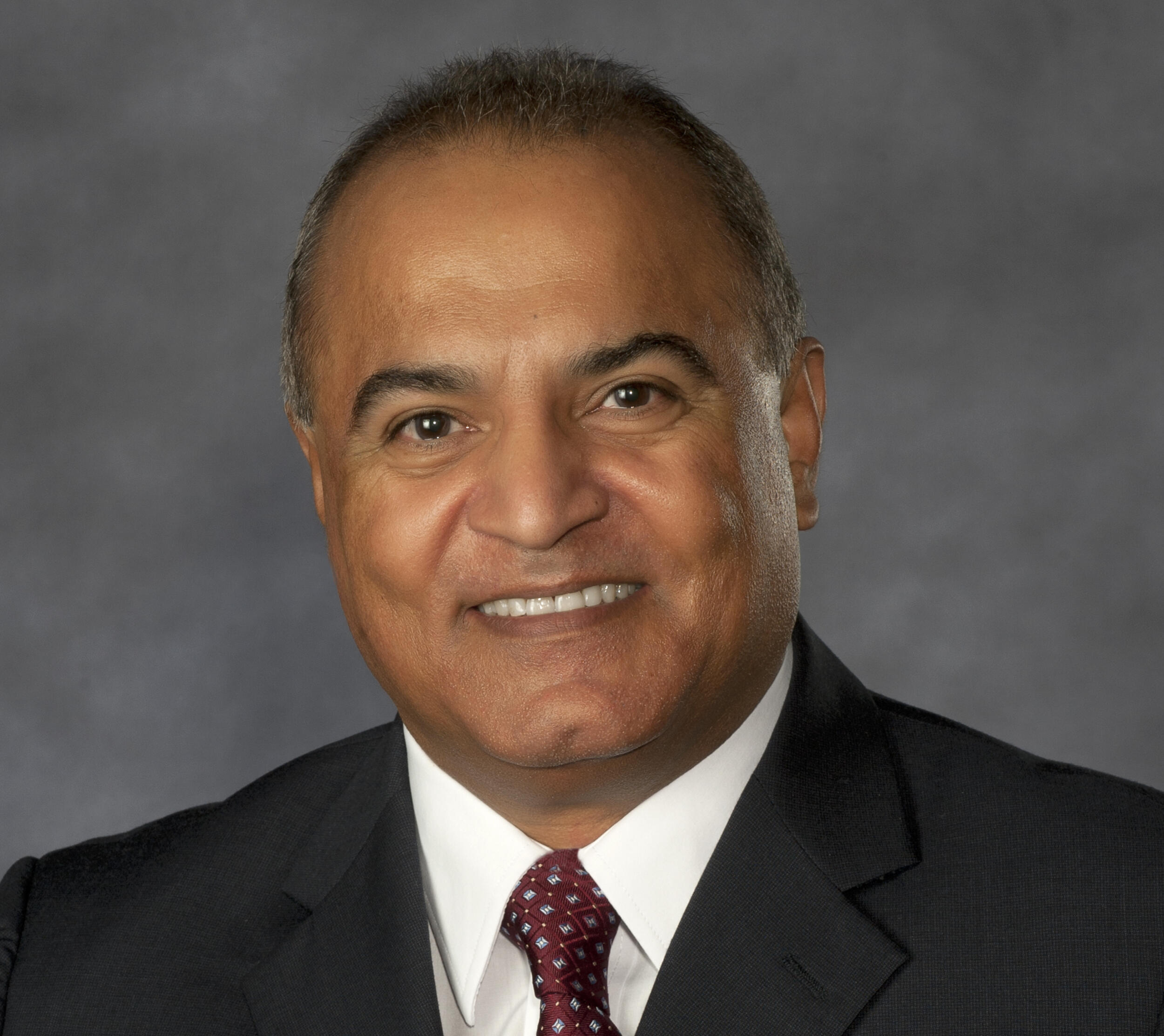 A portrait of a man wearing a suit and tie 