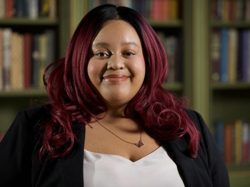 A portrait of a woman smiling at the camera.