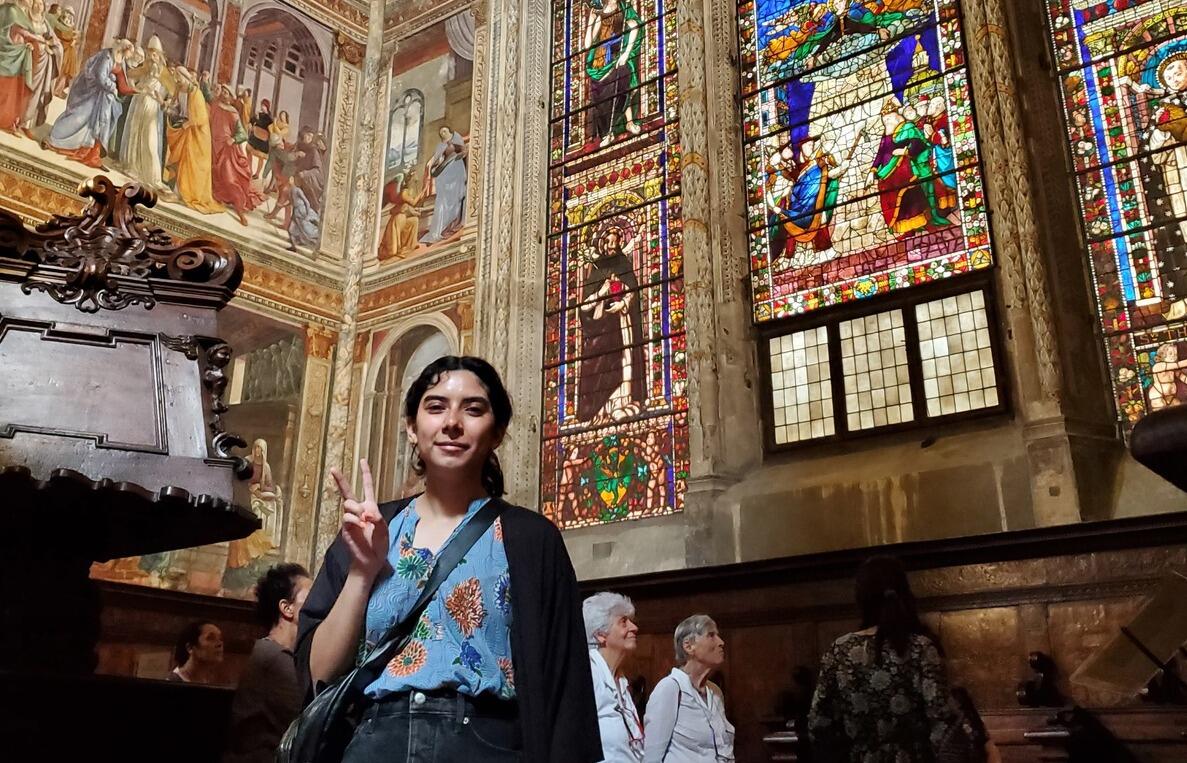 Ivania Del Cid standing in front of stain glass windows 