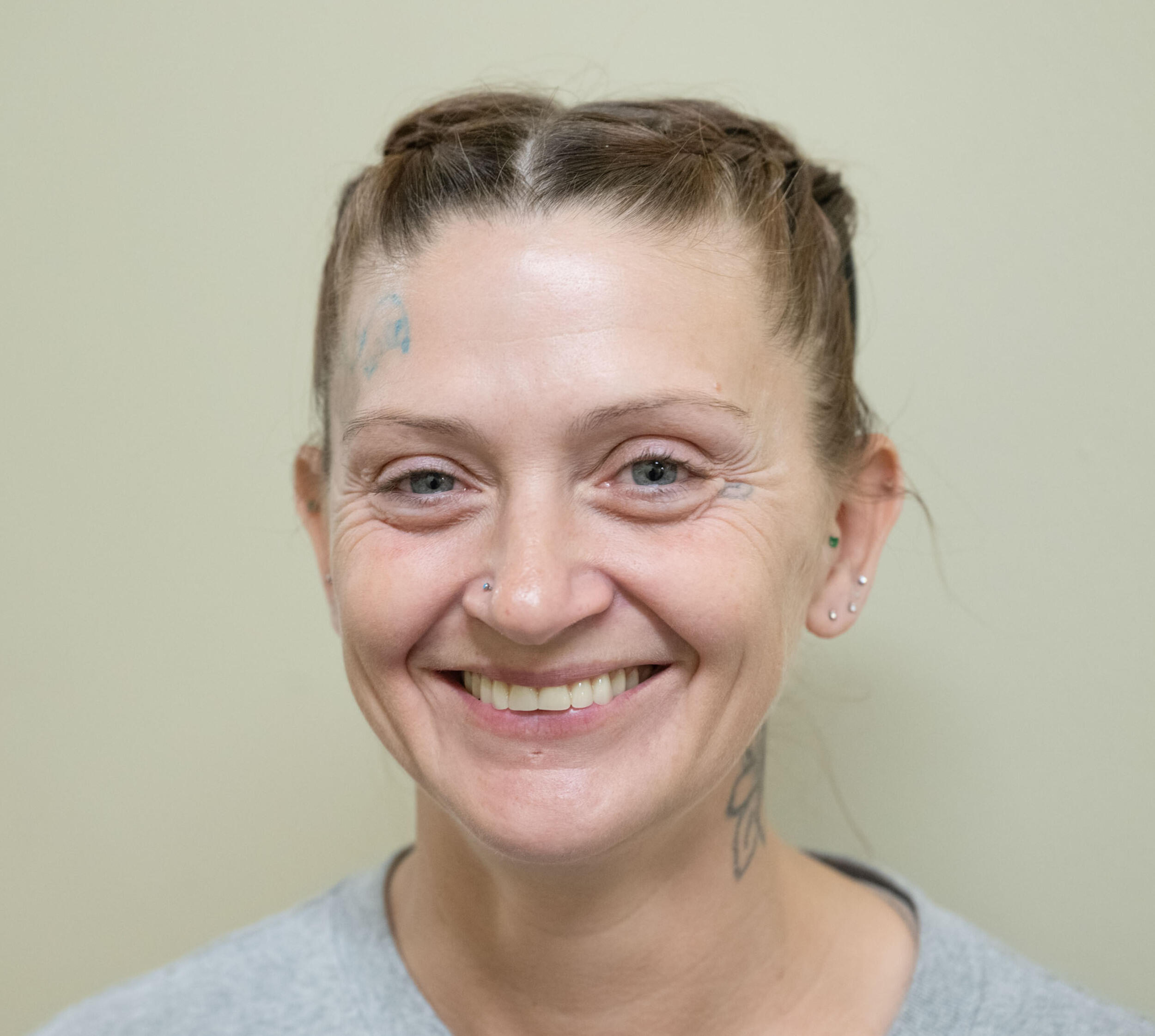 A photo of a woman from the shoulders up. She is smiling. 