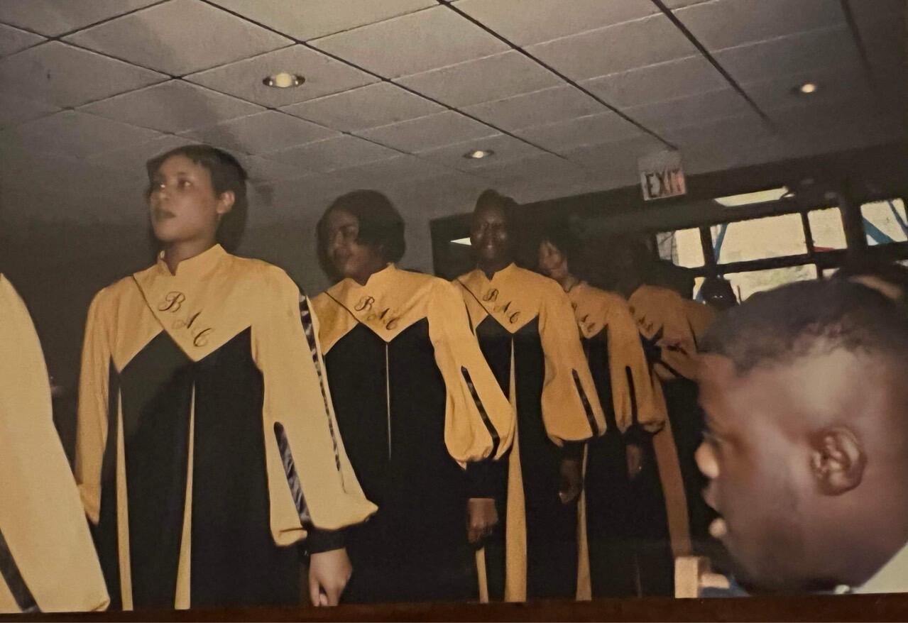 Black Awakening Choir members line up wearing matching robes.