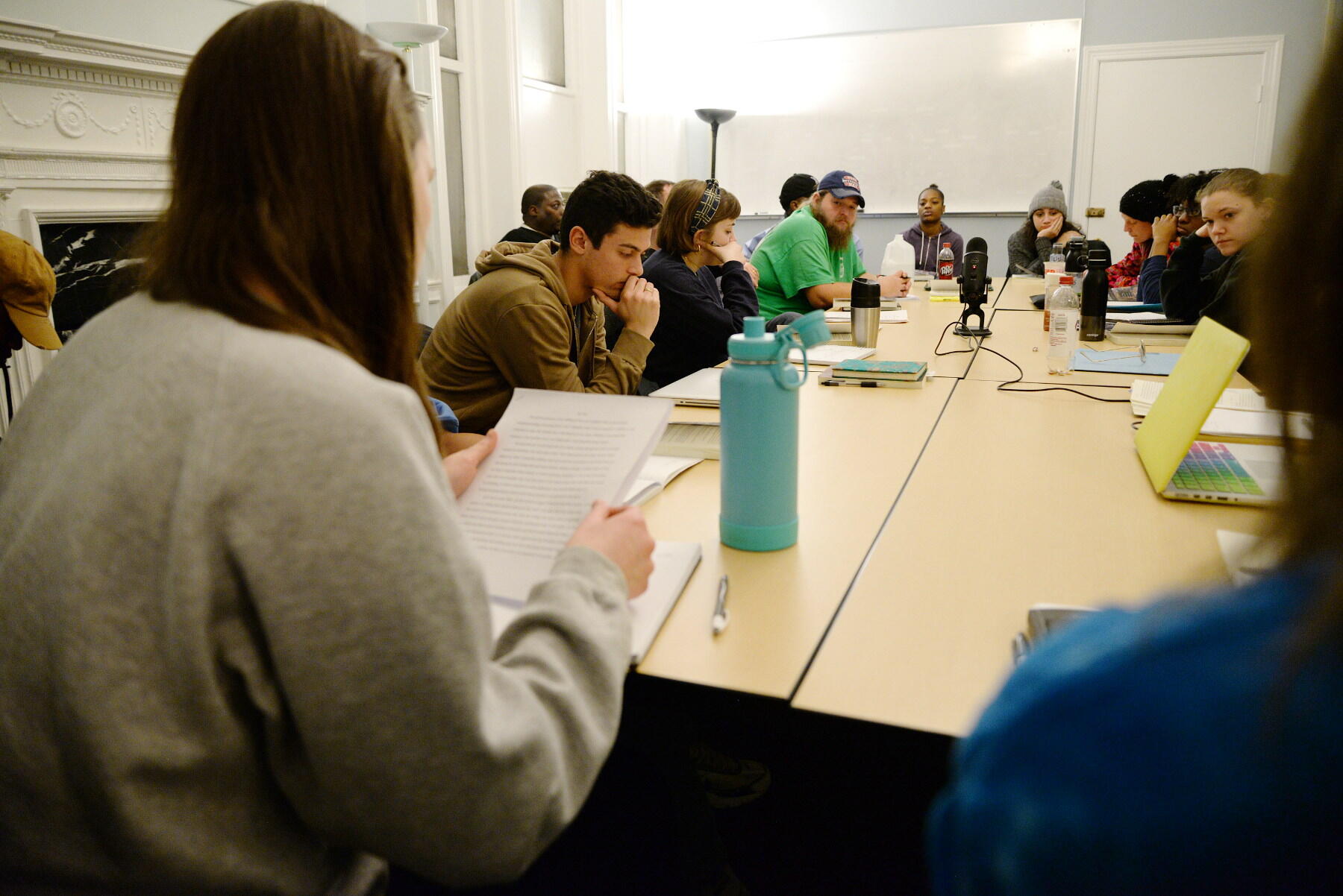 A student reads a piece of self-reflecting writing she wrote before her classmates during a recent Writing Your Way Out class.
