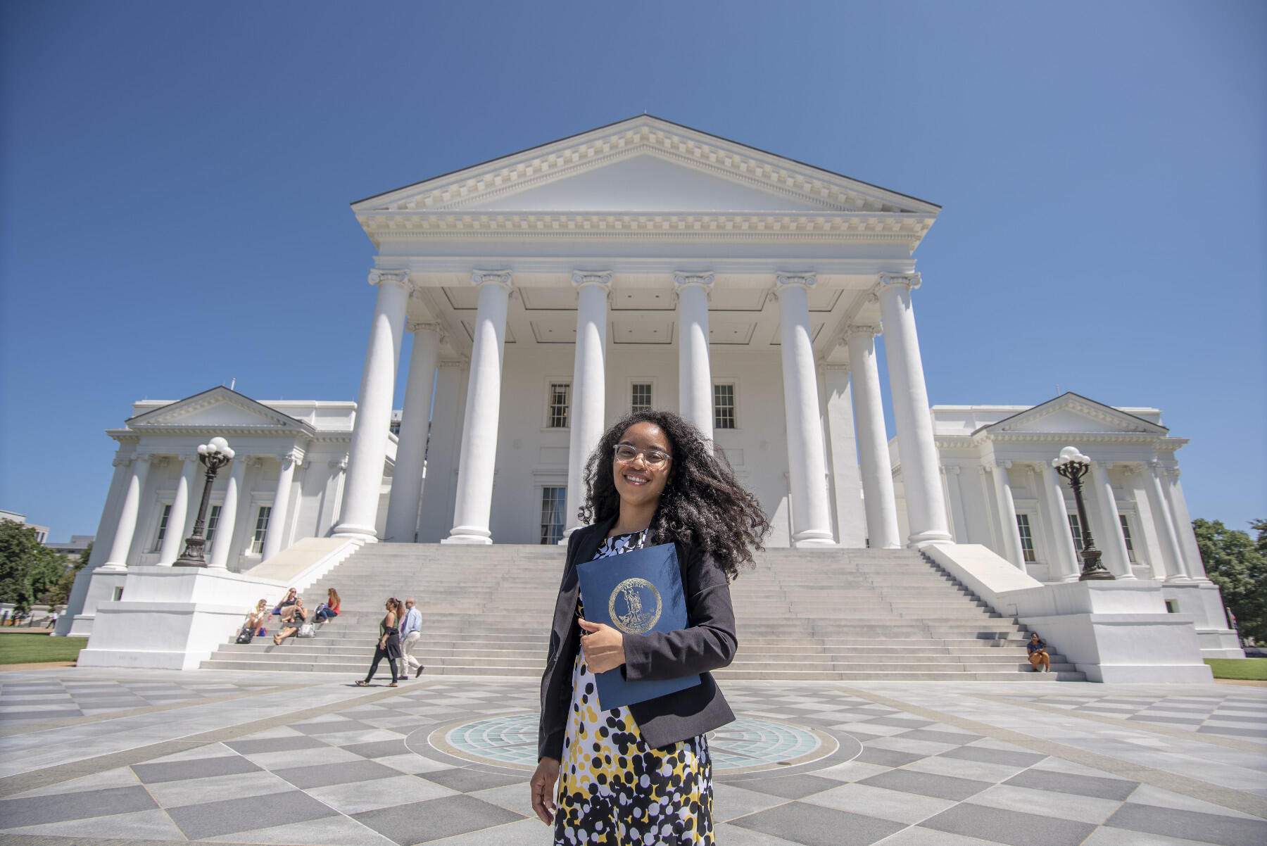 Woman standing in front of Capitol of Virginia.