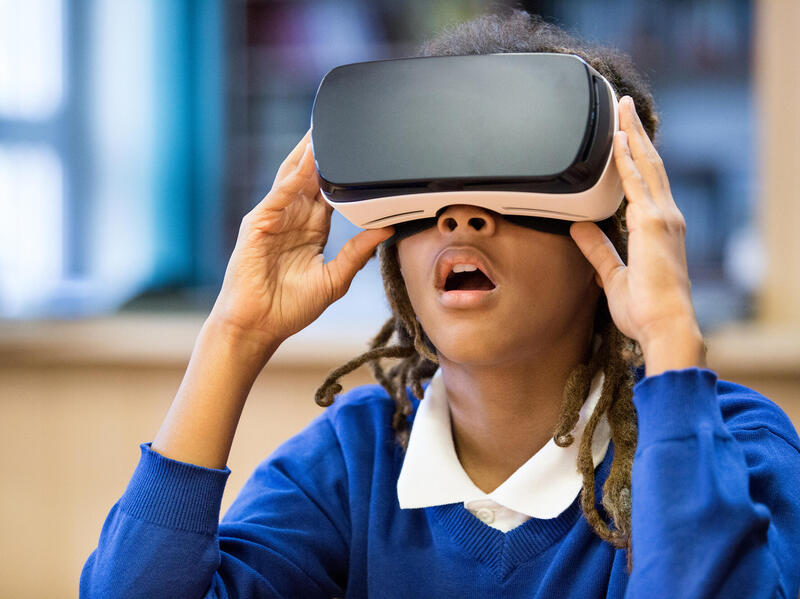 A photo of a teenage girl wearing 3D goggles. 