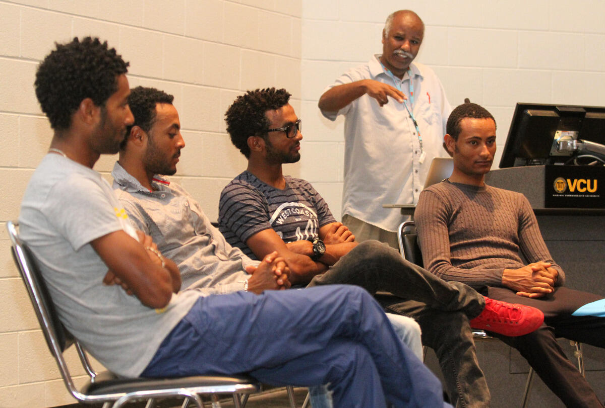 Ghidewon Abay-Asmerom, Ph.D., associate professor of mathematics, welcomes the Eritrean National Cycling Team.