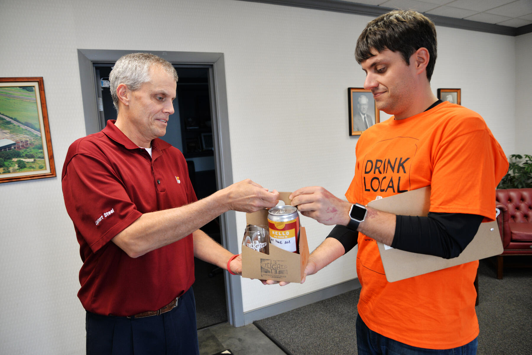 Matthew Teachey, right, delivers two crowlers of beer from Triple Crossing Brewing and two Flight glasses to an office in Richmond. The delivery, in late March, came as Flight was prototyping different delivery models.
