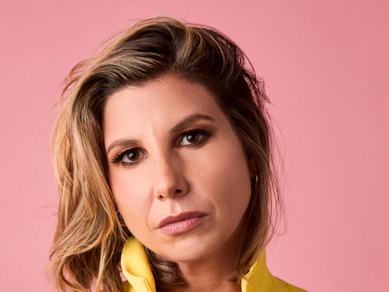 Head and shoulders image of Jessica Hendry Nelson, holding her collar.