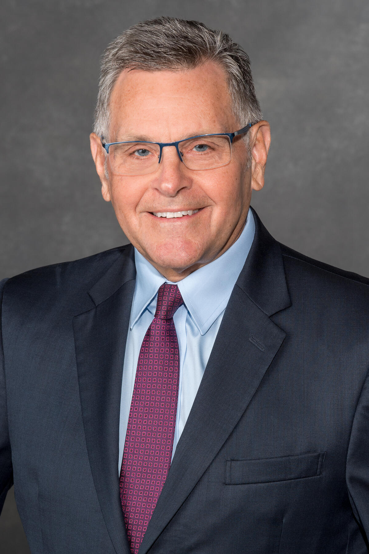 A portait of a man from the chest up. 