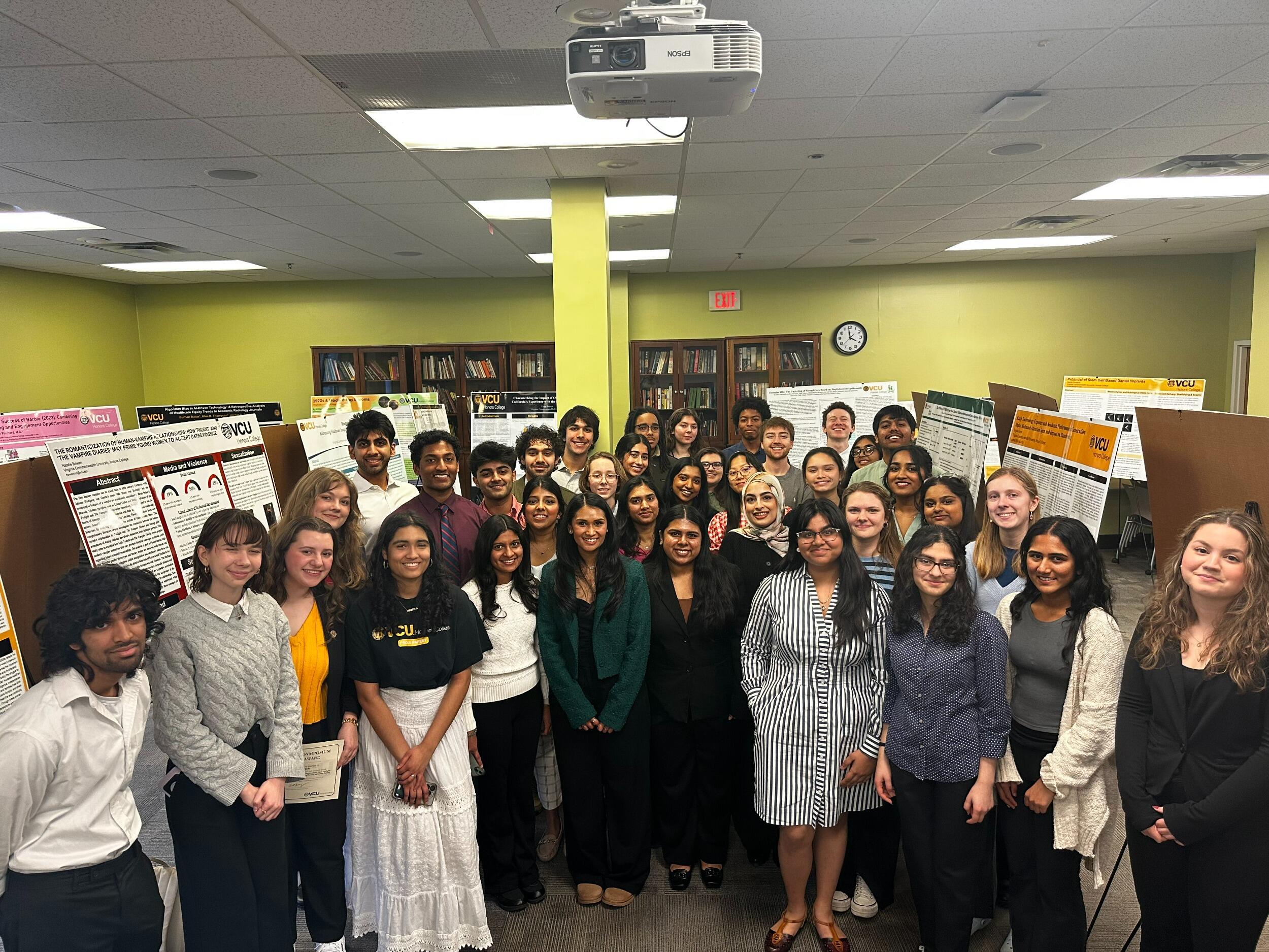 A group photo of 38 people standing in a room. 