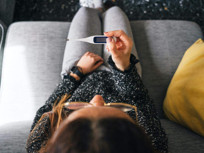 Woman reading thermometer. 