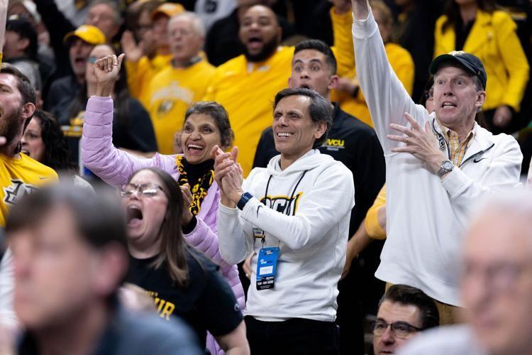 People cheering in a sports event crowd.