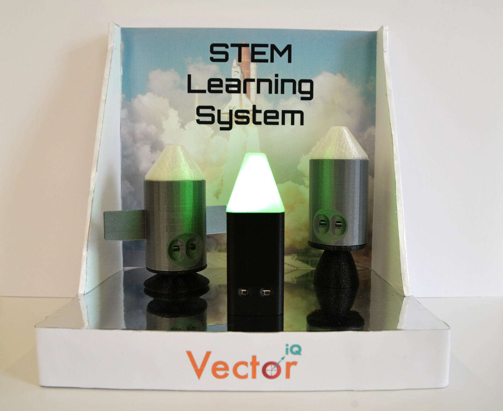 The company’s learning system device, called the Vector iQ Learning System, looks a bit like a series of model rocket ships, each featuring lights and sounds. 