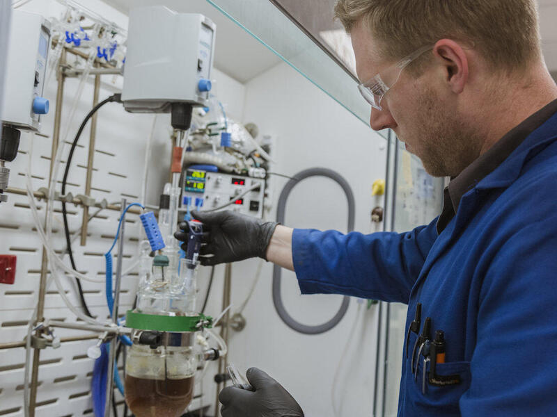 An employee runs tests in the Medicines for All lab at the VCU College of Engineering. 