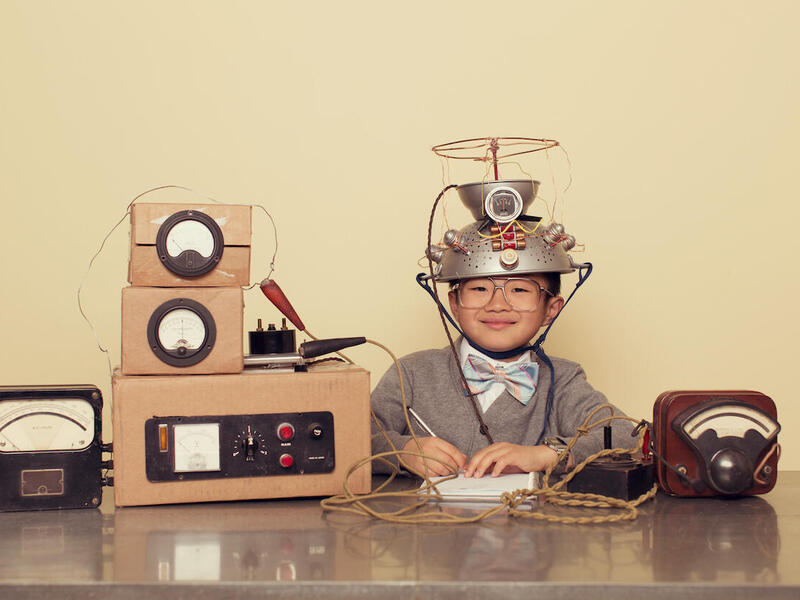 A child wearing a helmet hooked up to measuring equipment.