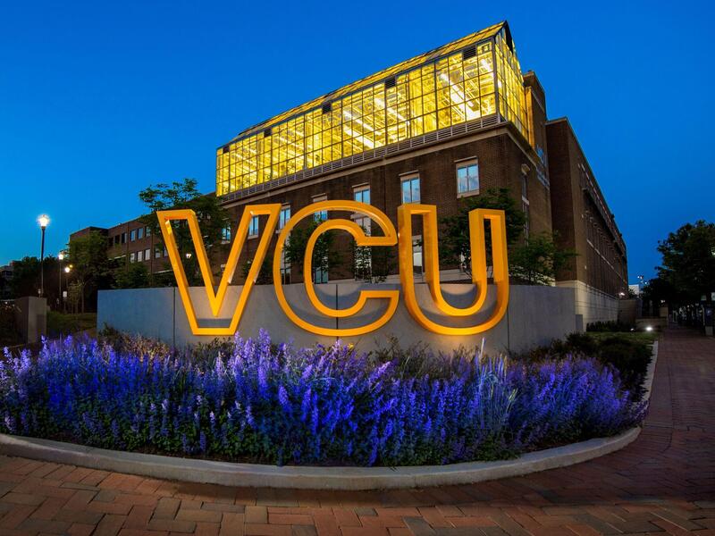VCU sign lit up at night.