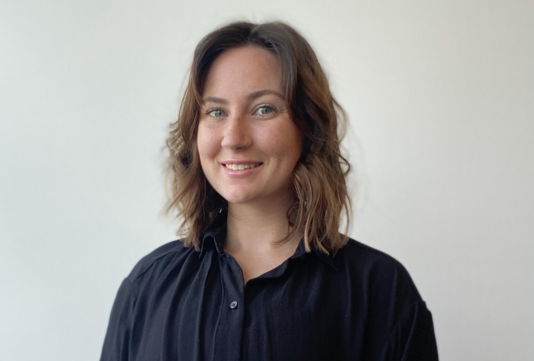 A photo of a woman from the chest up. 
