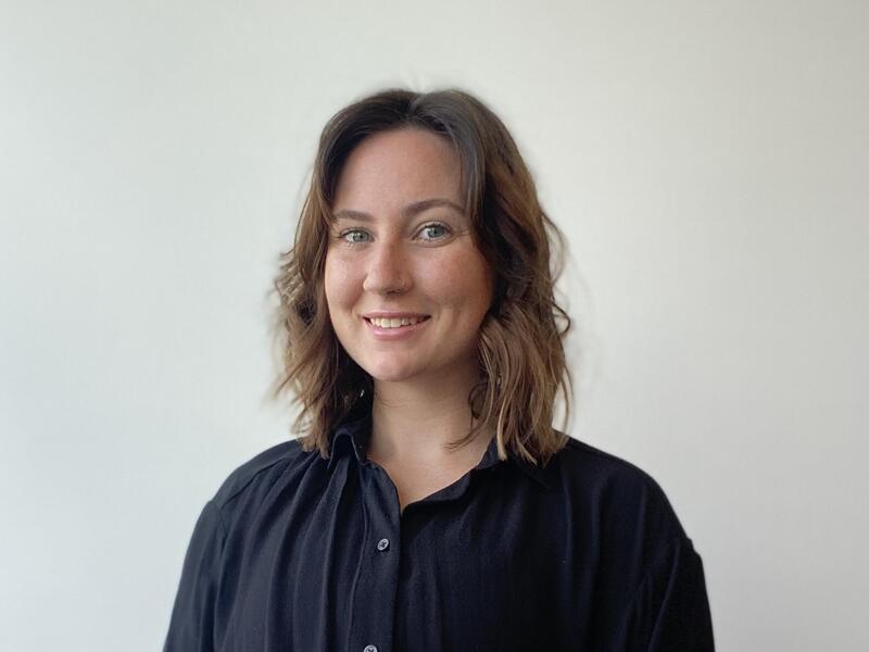 A photo of a woman from the chest up. 